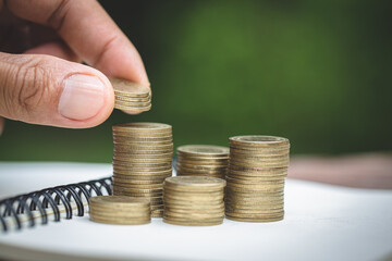 Human hand  putting coins money stack step growing growth saving money, deposit Close up of person hand stacking golden coins, Concept finance business investment.