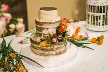 white double-decker cake adorned with flowers