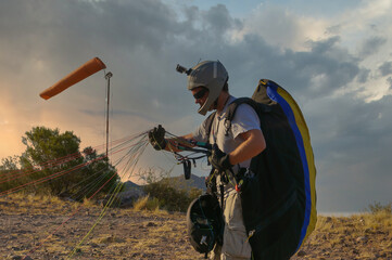 paraglider pilot assembling equipment