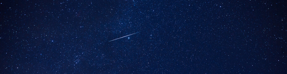 Panorama  blue night sky and  Geminids Meteor Shower 2020.with noise and  grain.Photo by long...