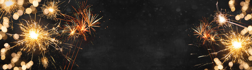 Silvester background banner panorama long- firework and sparklers on dark black night texture, with space for text