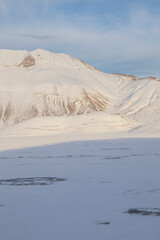 
Plain of Castelluccio di Norcia and Monte Vettore. Landscape covered with white snow seen from drone. uncontaminated landscape, the silence of nature