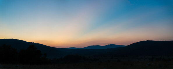 Panoramic image of amazing sunset behind a mountain, Croatia.