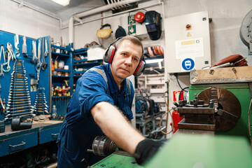 Marine engineer officer controlling vessel enginesand propulsion in engine control room ECR. Ship onboard maintenance