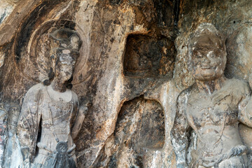 Fototapeta na wymiar Longmen Grottoes with Buddha's figures are Starting with the Northern Wei Dynasty in 493 AD. It is one of the four notable grottoes in China.