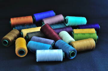spools of thread on a black background