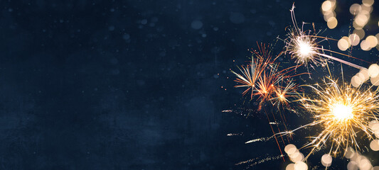Silvester Festival Party New Year 2024 Fireworks background banner panorama - firework and sparklers on rustic dark blue night sky texture - Powered by Adobe