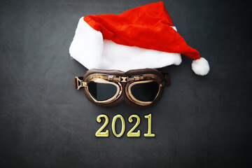 Santa Claus hat, glasses and nose with face mask on red background. Christmas or New Year celebration concept.