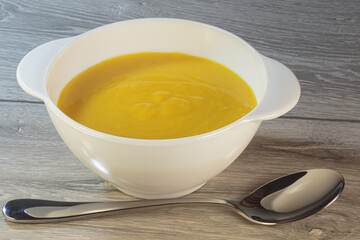 Traditional American pumpkin yellow soup.