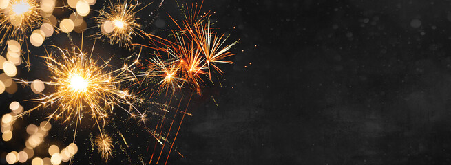 Silvester background banner panorama long- firework and sparklers on dark black night texture, with space for text - Powered by Adobe