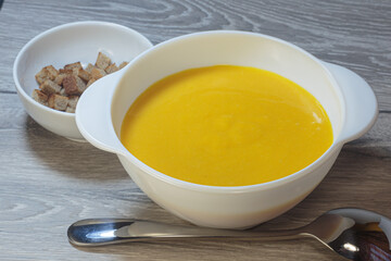 Traditional American pumpkin yellow soup.