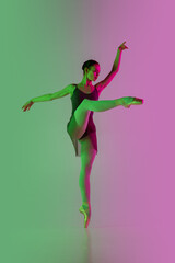 Fototapeta na wymiar Directive. Young and graceful ballet dancer isolated on gradient pink-green studio background in neon. Art, motion, action, flexibility, inspiration concept. Flexible ballerina, weightless jumps.
