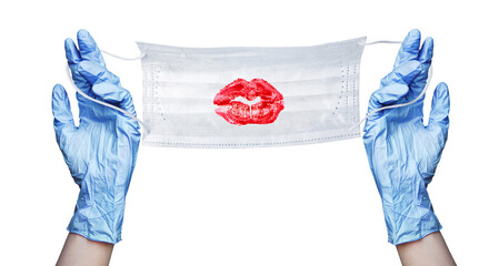 Hands in blue rubber medical gloves, protective medical mask, red sexy lips, lipstick kiss print on white background isolated close up, coronavirus protection on Valentine's Day, romantic love holiday