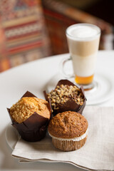 Latte in tall glass and desserts