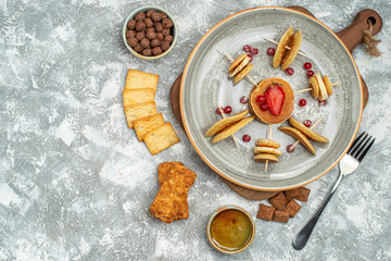 Buttermilk fruit pancakes cookies biscuits and honey on blue background