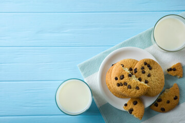 Delicious cookies with chocolate chips on a colored background