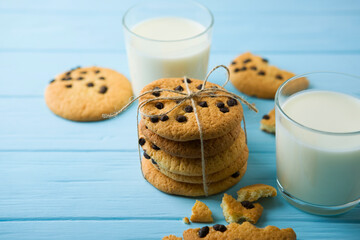 Delicious cookies with chocolate chips on a colored background
