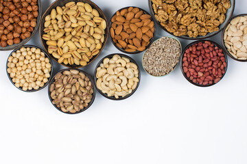Different types of nuts in composition on white background in studio