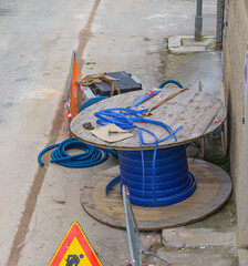 Worker inserts fiber optic cables buried in a micro trench