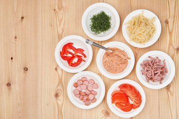 Cooking pizza, raw ingredients on a wooden tabletop. Tasty, fresh, homemade food. Top view, close-up with copy space.