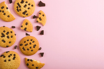Delicious cookies with chocolate chips on a colored background