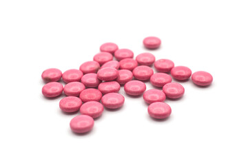 Obraz na płótnie Canvas Closeup of pink small candies on white background