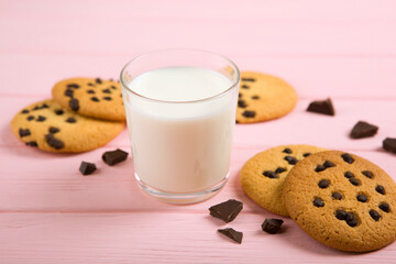 Delicious cookies with chocolate chips on a colored background