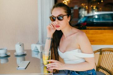 Young glamour sexy woman posing with juice