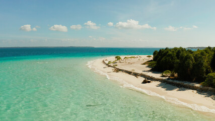 Sandy beach and turquoise water in the blue lagoon, aerial view. Patawan island with sandy beach. Summer and travel vacation concept.