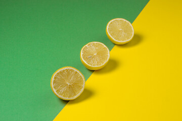 Lemons on a yellow-green background. Citrus fruit. Sliced lemon. Healthy food. Sour fruit
