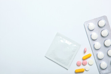 condoms and other contraceptives on a colored background