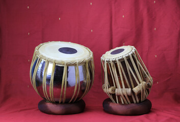Indian tabla drums on a red background - obrazy, fototapety, plakaty