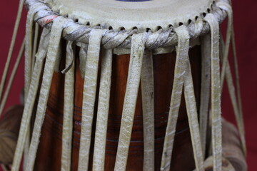 Indian tabla drums on a red background.