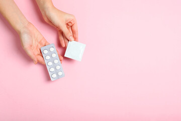 condoms and other contraceptives on a colored background - obrazy, fototapety, plakaty