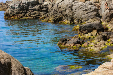 Spain mediterranean sea. A cove surrounded by stones.