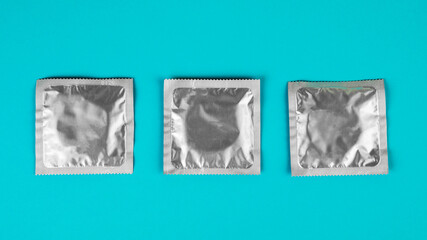 Condom on a blue background. The concept of safe sex.