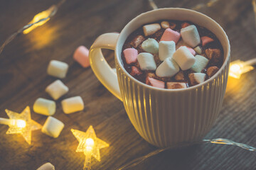 Cup of hot cocoa with marshmallows on the wooden table, top view