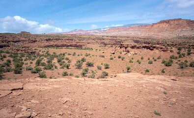Amazing sandstone monoliths in a barren desert prairie on a blue partly cloudy summer day at Capitol Reef National Park in Torrey Utah