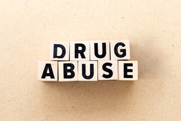 Alphabet letter block in word drug abuse on wood background