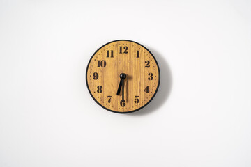 wood office wall clock with white dial on white background. wall clock on white background, top...