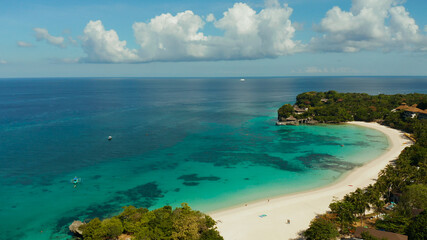 Travel concept: sandy beach and hotels near the blue lagoon, from above, Boracay, Philippines. Seascape with beach on tropical island. Summer and travel vacation concept.