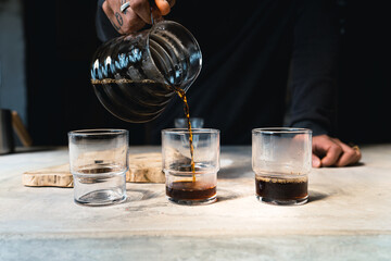 Drip coffee, barista pouring water on coffee ground with filter