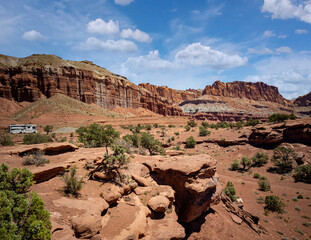 Amazing sandstone monoliths in a barren desert prairie on a blue partly cloudy summer day at Capitol Reef National Park in Torrey Utah