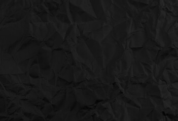 Black crumpled paper texture background.