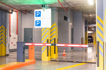 Barrier at the entrance to the underground parking sign under the apartment building.