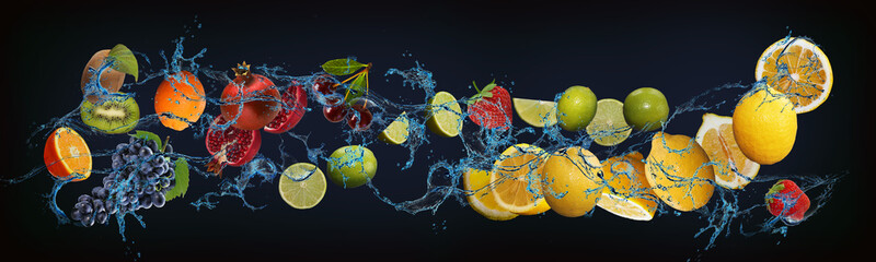 Panorama with fruits in water - juicy orange, grapes, kiwi, cherry, lime, lemon, strawberry - the...