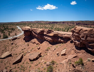 Amazing sandstone monoliths in a barren desert prairie on a blue partly cloudy summer day at Capitol Reef National Park in Torrey Utah