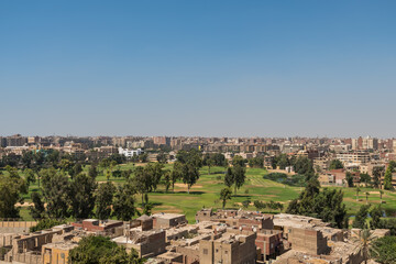 Fototapeta na wymiar Aerial view of Cairo of red brick houses from the Giza pyramid complex, the Giza Necropolis, on the Giza Plateau in Greater Cairo, Egypt