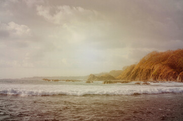 Beach Sunset landscape in Costa Rica. Wave and sky Rocks