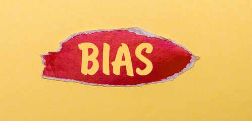 On a yellow background, a sheet of red paper with the word BIAS.